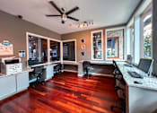Thumbnail 47 of 51 - A room with a wood floor and a ceiling fan.