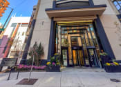 Thumbnail 42 of 42 - a view of the front of a tall building with a blue sky