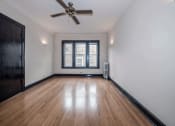 Thumbnail 14 of 18 - an empty room with hardwood floors and a ceiling fan