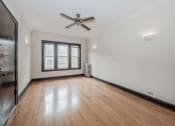 Thumbnail 13 of 18 - an empty room with hardwood floors and a ceiling fan