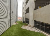 Thumbnail 26 of 29 - a grassy area between two buildings