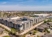 Thumbnail 29 of 29 - an aerial view of a large apartment complex with a city in the background