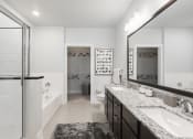 Thumbnail 17 of 29 - a bathroom with a large mirror and two sinks