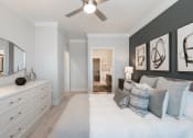 Thumbnail 16 of 29 - a bedroom with a bed and a ceiling fan
