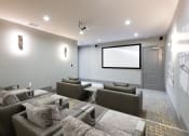 Thumbnail 22 of 29 - a large screening room with couches and a projector