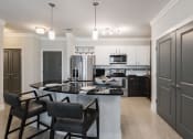 Thumbnail 11 of 29 - a kitchen and dining area in a 555 waverly unit