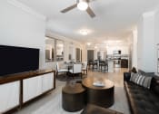 Thumbnail 13 of 29 - a living room and dining room with white walls and a ceiling fan
