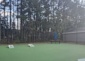 Thumbnail 11 of 49 - A table tennis court with a green surface and a white table tennis table.