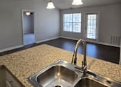 Thumbnail 37 of 49 - A kitchen with a sink and a ceiling fan.