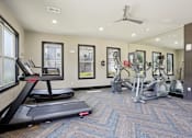 Thumbnail 53 of 69 - A treadmill is in the foreground of a well-equipped gym at Highline Urban Lofts Apartments, Cypress, Texas