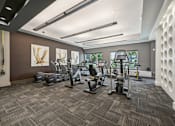 Thumbnail 15 of 48 - A gym with a variety of exercise equipment at Everra Midtown Park Apartments, Dallas, TX, 75231