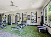 Thumbnail 52 of 69 - A gym with a variety of equipment including weights and a treadmill at Highline Urban Lofts Apartments, Texas