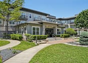 Thumbnail 62 of 69 - A large grassy area in front of apartment buildings at Highline Urban Lofts Apartments, Cypress, Texas