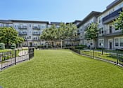 Thumbnail 43 of 69 - A grassy area in front of apartment buildings at Highline Urban Lofts Apartments, Cypress, Texas