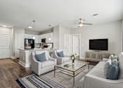 Thumbnail 1 of 69 - A living room with a grey couch, a coffee table, and a television at Highline Urban Lofts Apartments, Cypress, TX, 77429