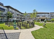 Thumbnail 44 of 69 - A sunny day at a residential complex with a green lawn and a black fence at Highline Urban Lofts Apartments, Texas