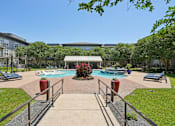 Thumbnail 61 of 69 - A pool surrounded by a metal fence and a red fire hydrant at Highline Urban Lofts Apartments, Cypress, TX, 77429