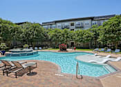 Thumbnail 60 of 69 - A large outdoor swimming pool surrounded by lounge chairs and umbrellas at Highline Urban Lofts Apartments, Cypress, TX, 77429