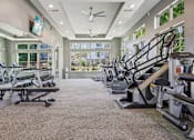 Thumbnail 28 of 53 - Gym with modern machines at Vine + Vail Townhomes and Apartments, Grapevine Texas