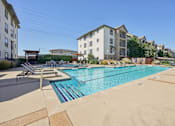 Thumbnail 23 of 53 - pool surrounded by a concrete floor at Vine + Vail Townhomes and Apartments, Grapevine, TX