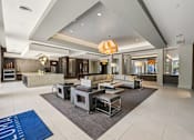 Thumbnail 34 of 48 - A spacious living room with a large grey sofa set and a grey rug at Everra Midtown Park Apartments, Dallas, Texas