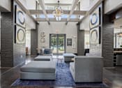 Thumbnail 28 of 69 - A large room with a blue rug and grey couches at Highline Urban Lofts Apartments, Texas, 77429