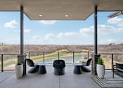 Thumbnail 20 of 39 - A patio with a view of a golf course and a lake.