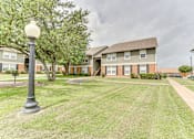 Thumbnail 38 of 40 - Two story apartment buildings with landscaped courtyard at Arbors Of Corsicana Apartments, Corsicana, Texas