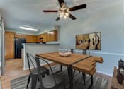 Thumbnail 3 of 32 - A dining room with a wooden table and chairs.
