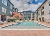 Thumbnail 35 of 53 - Outdoor swimming pool with surrounding courtyard at The Barton Apartments, Dallas, 75206