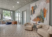 Thumbnail 17 of 53 - Lobby lounge with abstract artwork and seating at The Barton Apartments, Texas, 75206