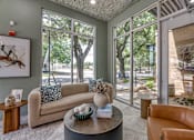 Thumbnail 16 of 53 - Lobby lounge with modern furniture and large windows at The Barton Apartments, Dallas, TX 75206