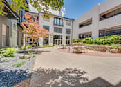 Thumbnail 43 of 53 - Courtyard patio with outdoor dining furniture at The Barton Apartments, Dallas, TX