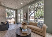 Thumbnail 19 of 53 - Lobby lounge with large windows and seating at The Barton Apartments, Dallas, 75206