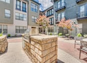 Thumbnail 37 of 53 - Courtyard with outdoor grills and seating area at The Barton Apartments, Dallas, Texas