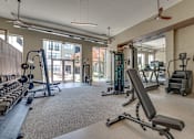 Thumbnail 25 of 53 - Fitness center with cardio and strength equipment at The Barton Apartments, Texas