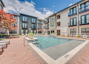 Thumbnail 34 of 53 - Swimming pool with hot tub and courtyard seating at The Barton Apartments, Dallas, TX 75206