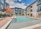 Thumbnail 39 of 53 - Pool courtyard with lounge seating and landscaping at The Barton Apartments, Dallas, 75206