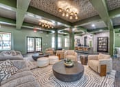 Thumbnail 17 of 69 - A living room with a large coffee table and a variety of seating options.