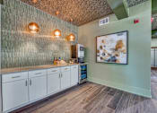Thumbnail 28 of 69 - A kitchen with a green wall and wooden floors.