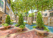 Thumbnail 42 of 69 - A pool surrounded by trees and plants.