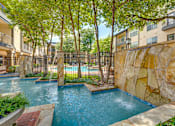 Thumbnail 34 of 69 - A pool surrounded by a fence and trees.