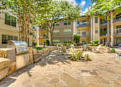Thumbnail 47 of 69 - A courtyard with a stone floor and a wall with a mailbox on it.