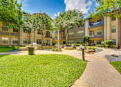 Thumbnail 64 of 69 - A sunny day at a well-maintained apartment complex with a walking path.