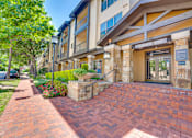 Thumbnail 68 of 69 - A brick pathway leads to a building entrance.