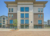 Thumbnail 36 of 39 - The Carter building has a brick facade and is surrounded by a fence.