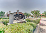 Thumbnail 38 of 42 - A sign for Copper Hill Apartment Homes is in front of a building at Copper Hill Apartments, Bedford, TX