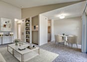 Thumbnail 1 of 42 - A living room with a white sofa, a coffee table, and a dining table with chairs at Copper Hill Apartments, Texas, 76021