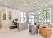Thumbnail 15 of 53 - Modern office with lounge seating and glass doors at The Barton Apartments, Texas