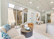 Thumbnail 14 of 53 - Modern lobby with textured ceiling and reception desk at The Barton Apartments, Texas, 75206